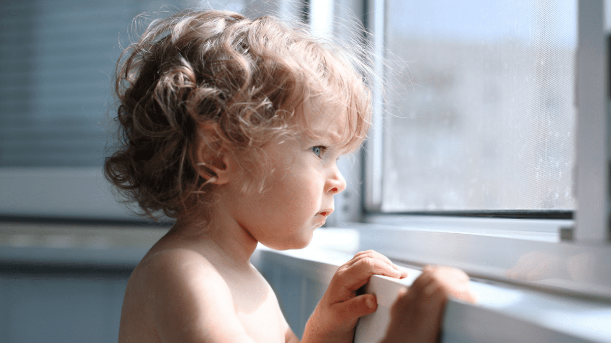 little boy looking out window