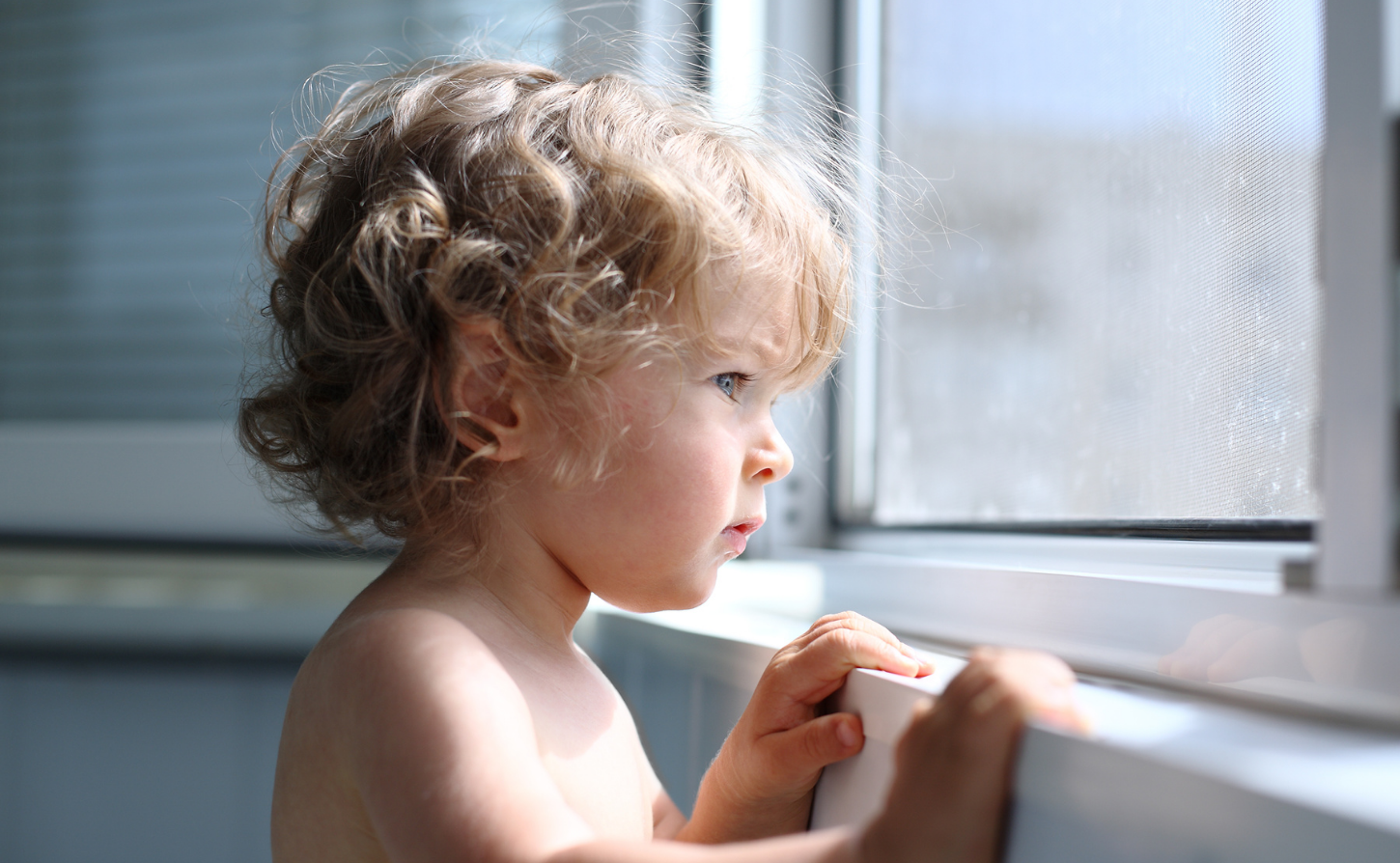 little boy looking out window