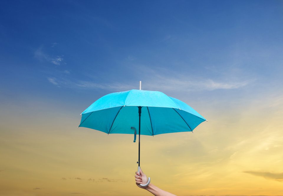 hand holding a blue umbrella up