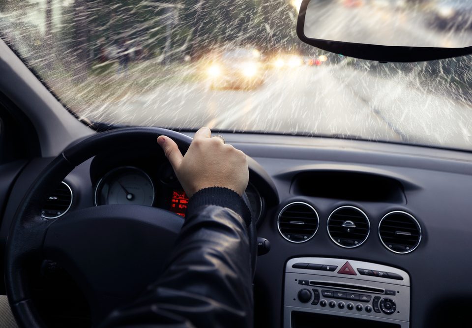 man driving car while it is snowing